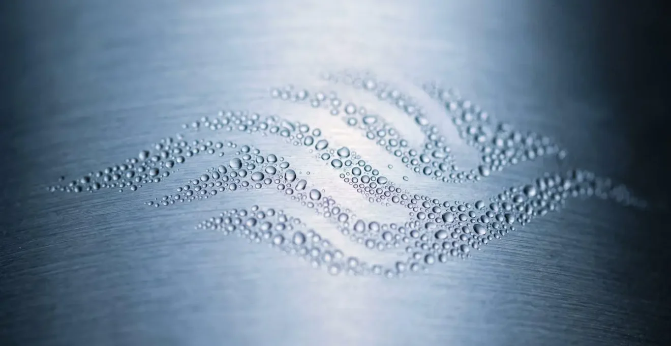Macro close-up of breath condensation pattern on smooth surface representing breathing rhythm