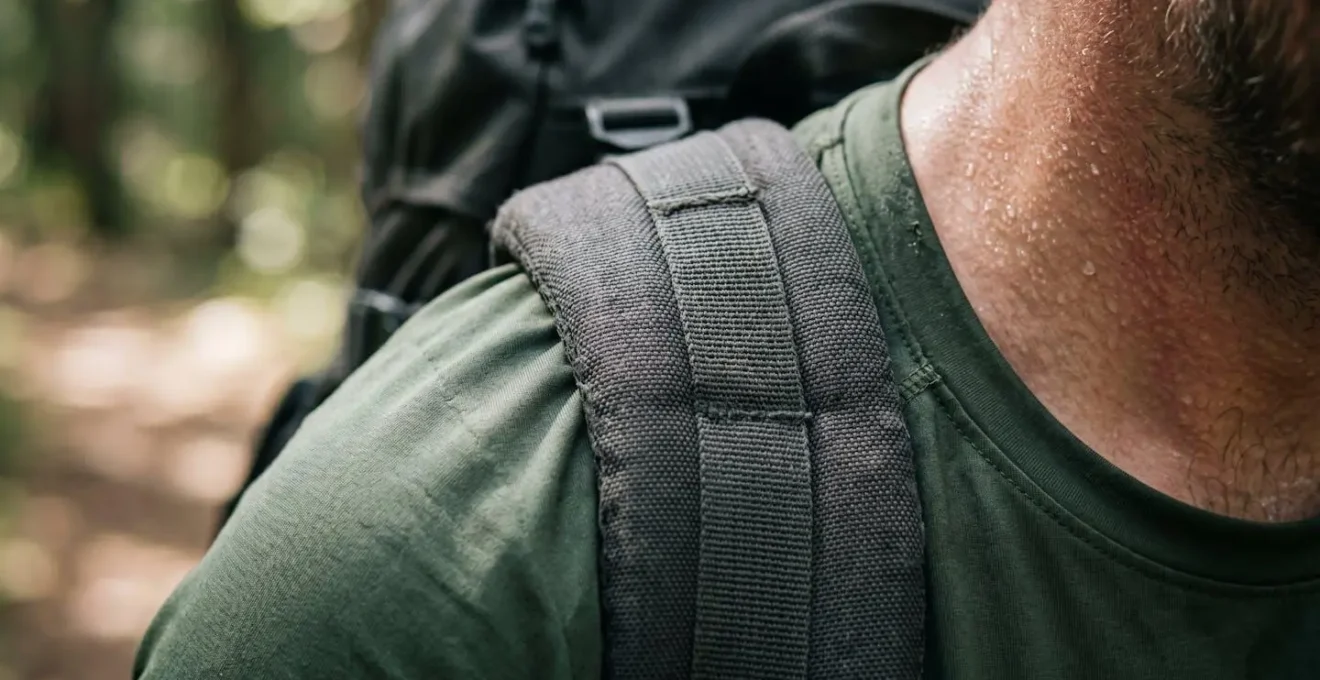 Close-up detail of proper rucking form showing weighted backpack positioning and posture alignment during walking