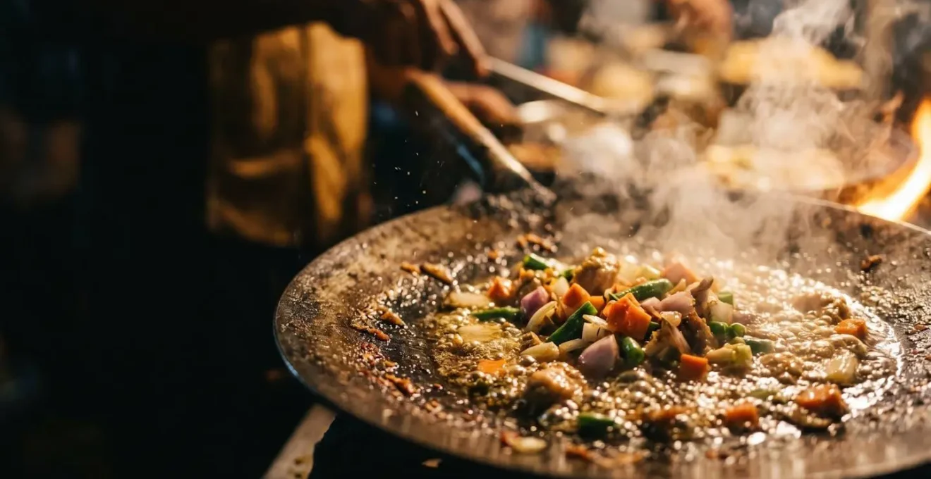 Close-up view of street food preparation showing high-heat cooking technique